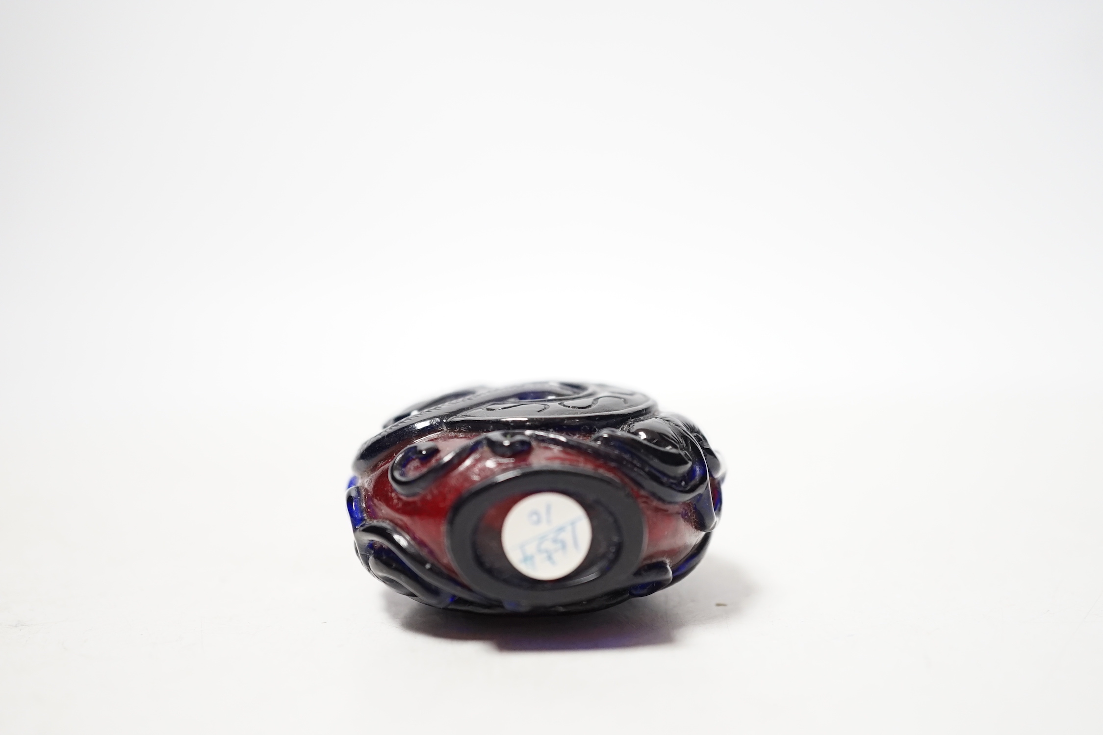 A Chinese amethyst and ruby glass ‘dragon’ snuff bottle, 19th century, 6cm high